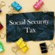 The photo says Social Security Tax. Notepad, pen, marker.