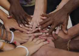 Many hands together: group of people joining hands