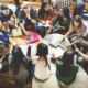 A group of students sit in a circle in a study group. Understanding barriers can better assist first generation college students in overcoming obstalces.