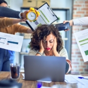 Group of business workers working together. Partners stressing one of them at the office which can lead to burnout at work.