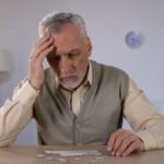 Older man trying to combine puzzle, having memory problems, cognitive impairment