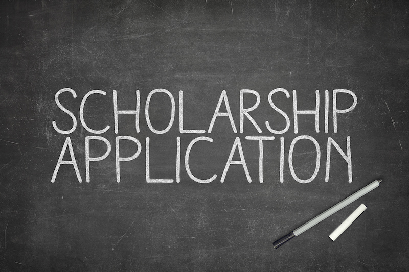 Scholarship application concept on blackboard with pen