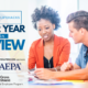 An African American woman and Caucasian man sit in an office reviewing paperwork. The titles "#FedLifeHacks" and "2022 Year in Review" are on the screen along with "Thanks to our 2022 FedLifeHack sponsors" along with BlueCross Blue Shield Federal Employee Program's logo and WAEPA's logo.