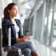 A female passenger sits at the gate at teh airprot. We asked the experts what to do when your flight gets canceled