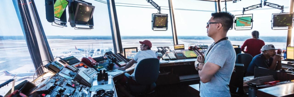 Air Traffic Controllers works in the control tower during a shift guiding flight navigation.