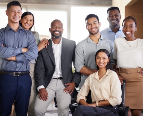 A group of diverse employees gather and smile for the camera. Labor Day is a great time to remind ourselves of the many advances we have made in the United States for rights and protections for the American Workforce.