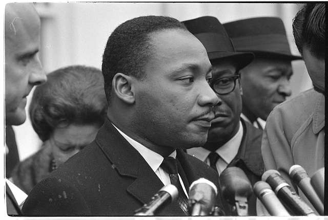 martin-luther-king-jr-head-and-shoulders-portrait-facing-right-at-microphones