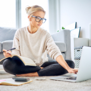 Woman using laptop paying bills online and managing home budget