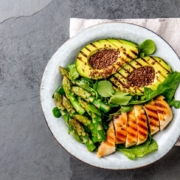 A plate shows a balanced diet with foods like avocado, asparagus, and salads to drive your nutrition.