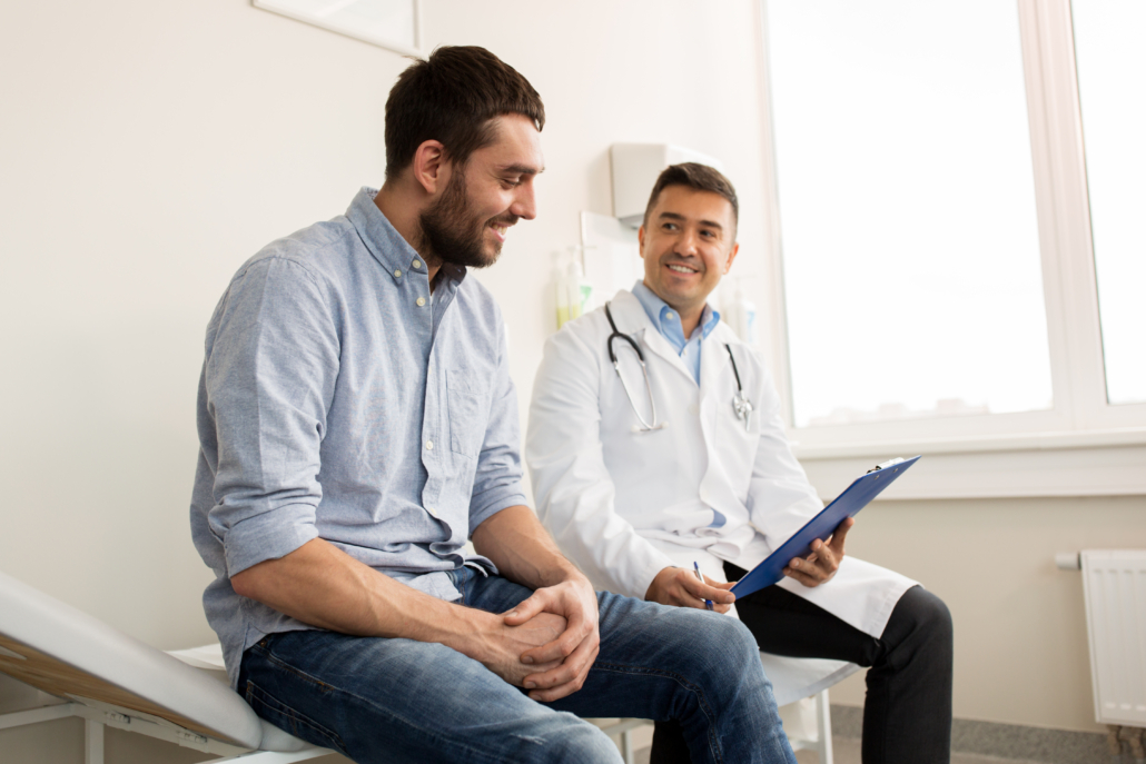 A male doctor meets with a male patient during men's health month