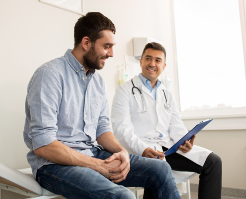 A male doctor meets with a male patient during men's health month