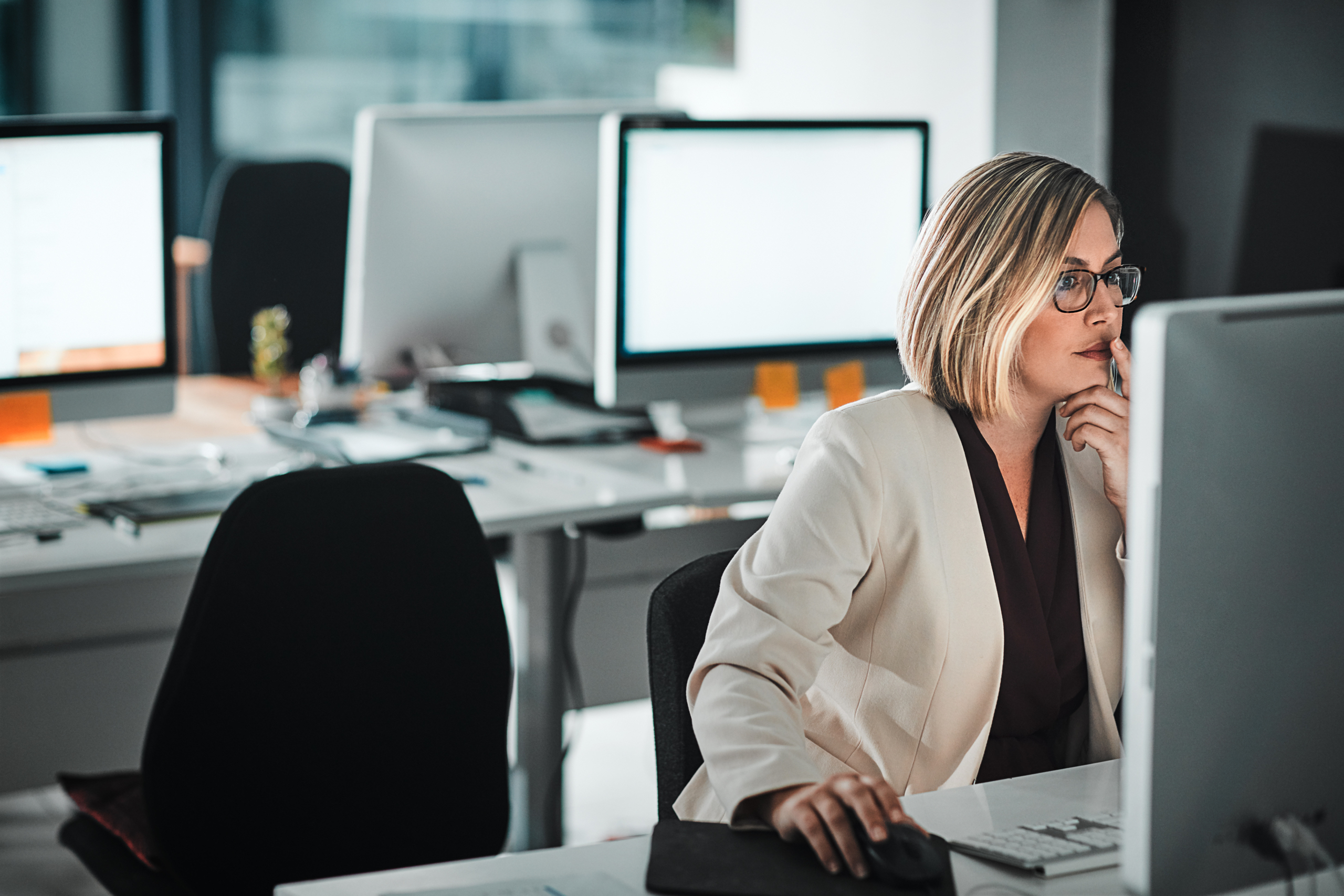 A woman works on her computer in the office. Having an email management plan can ensure an effective workflow efficiency